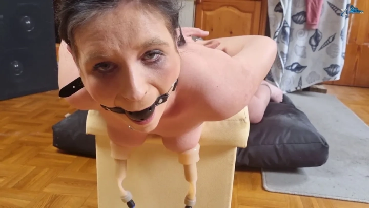 Dude in glasses bent over bed getting toyed from behind