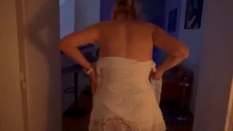 Blonde Milf in Lace Dress Teases in Dimly Lit Home Setting